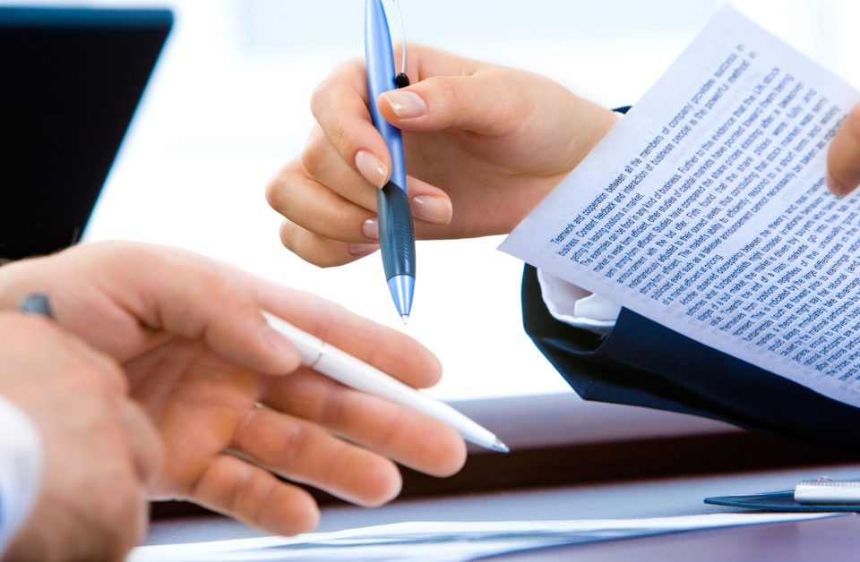 Picture of two business people reviewing some important documents about safety consultant expectations