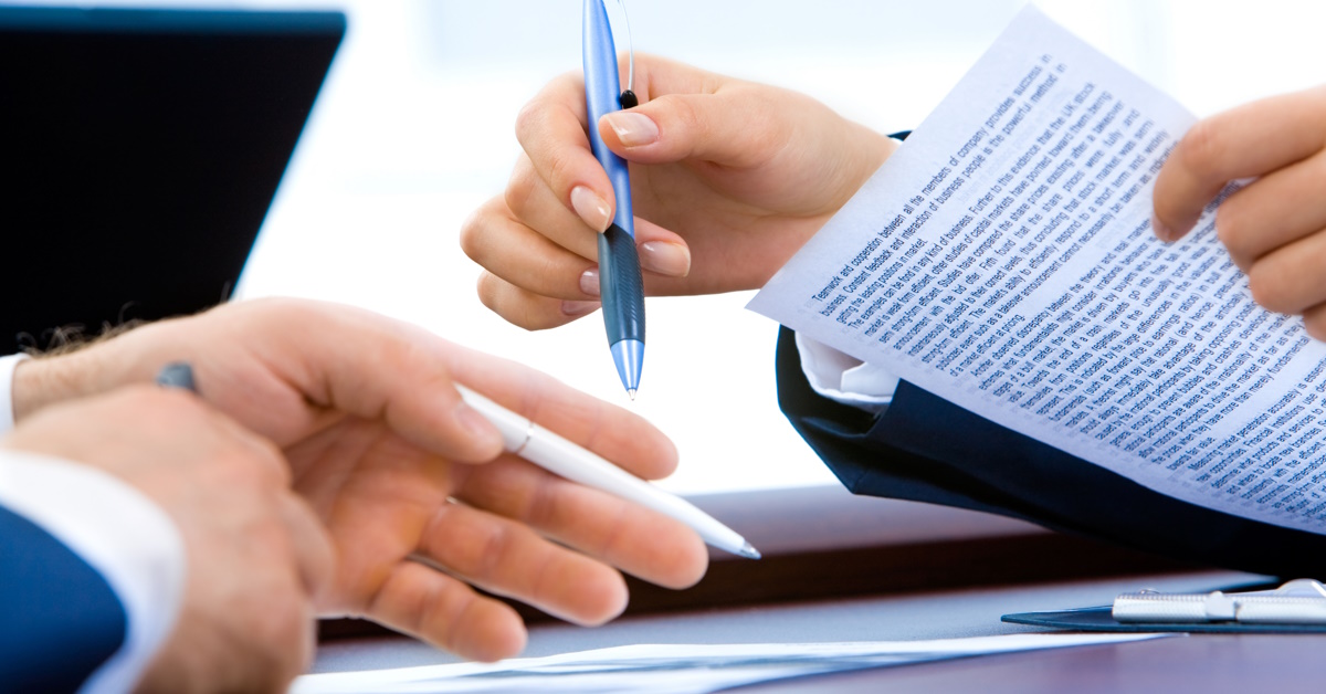 Picture of two business people reviewing some important documents about safety consultant expectations